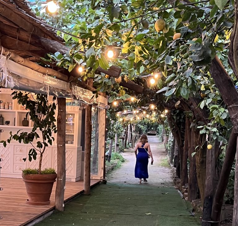 A woman walking through the lemon groves in Sorrento, Italy