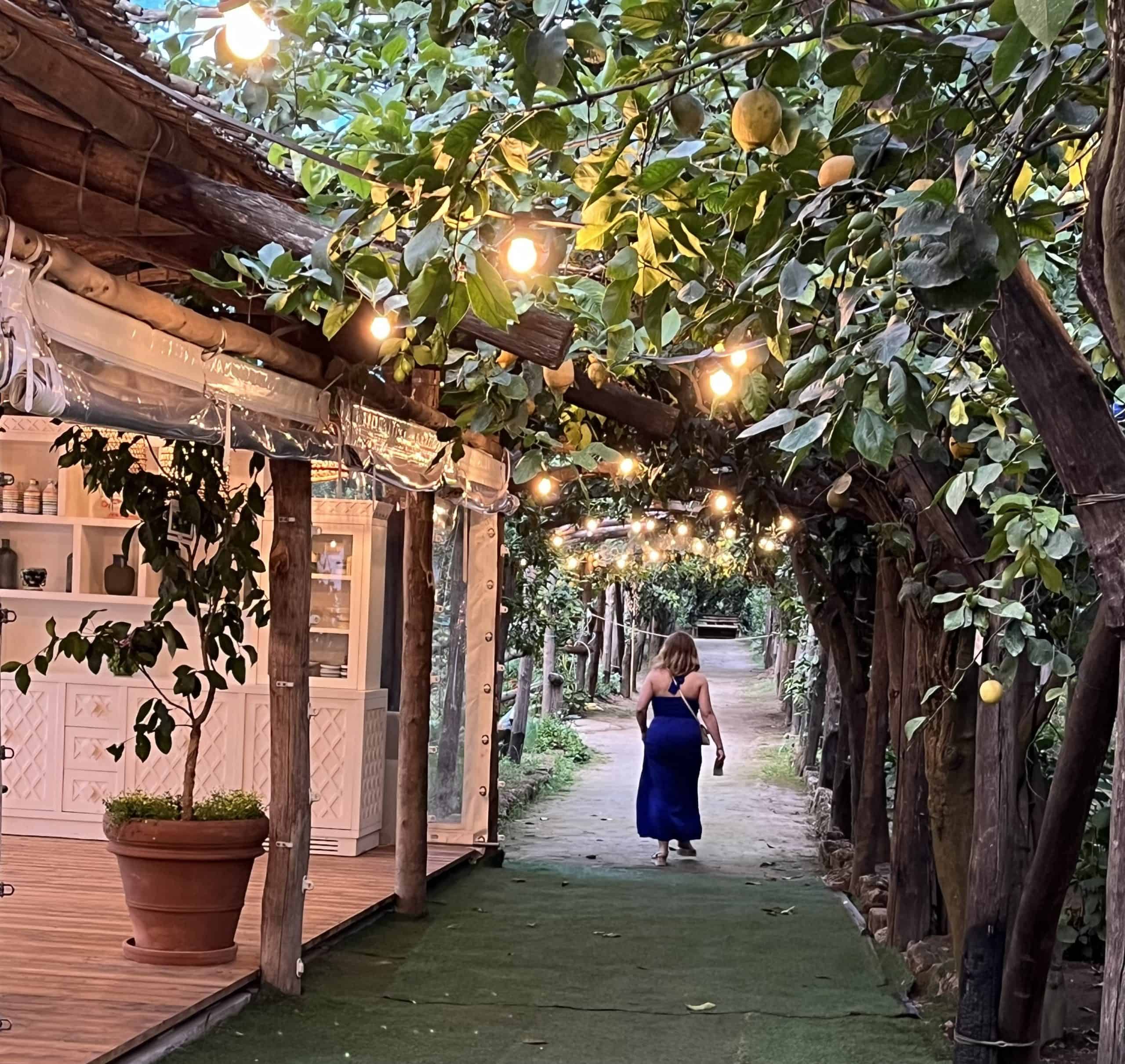 A woman walking through the lemon groves in Sorrento, Italy