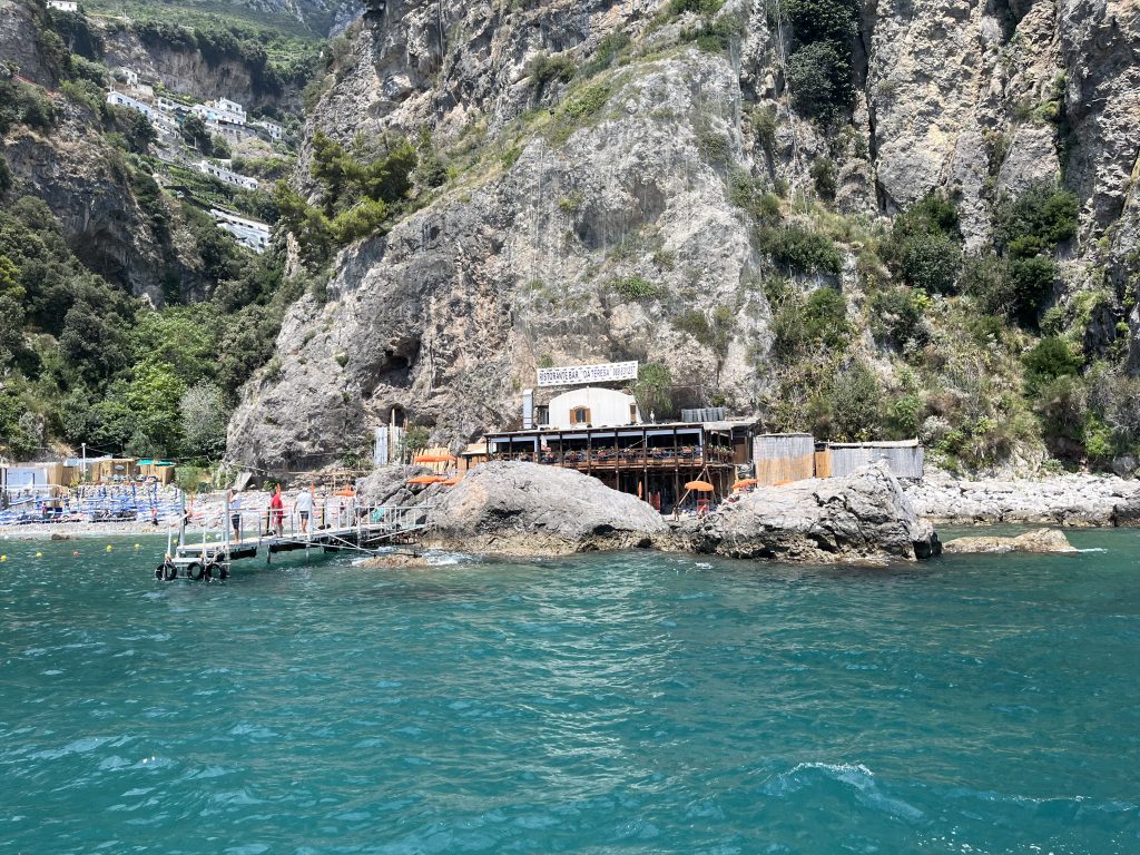 a restaurant on the Amalfi coast only accessible by sea with a private beach
