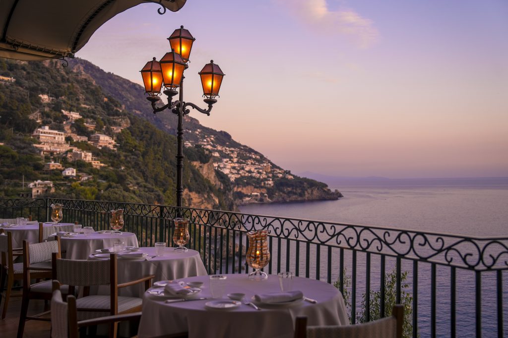 tables on an outdoor terrace overlooking the sea at Zass restaurant in Positano