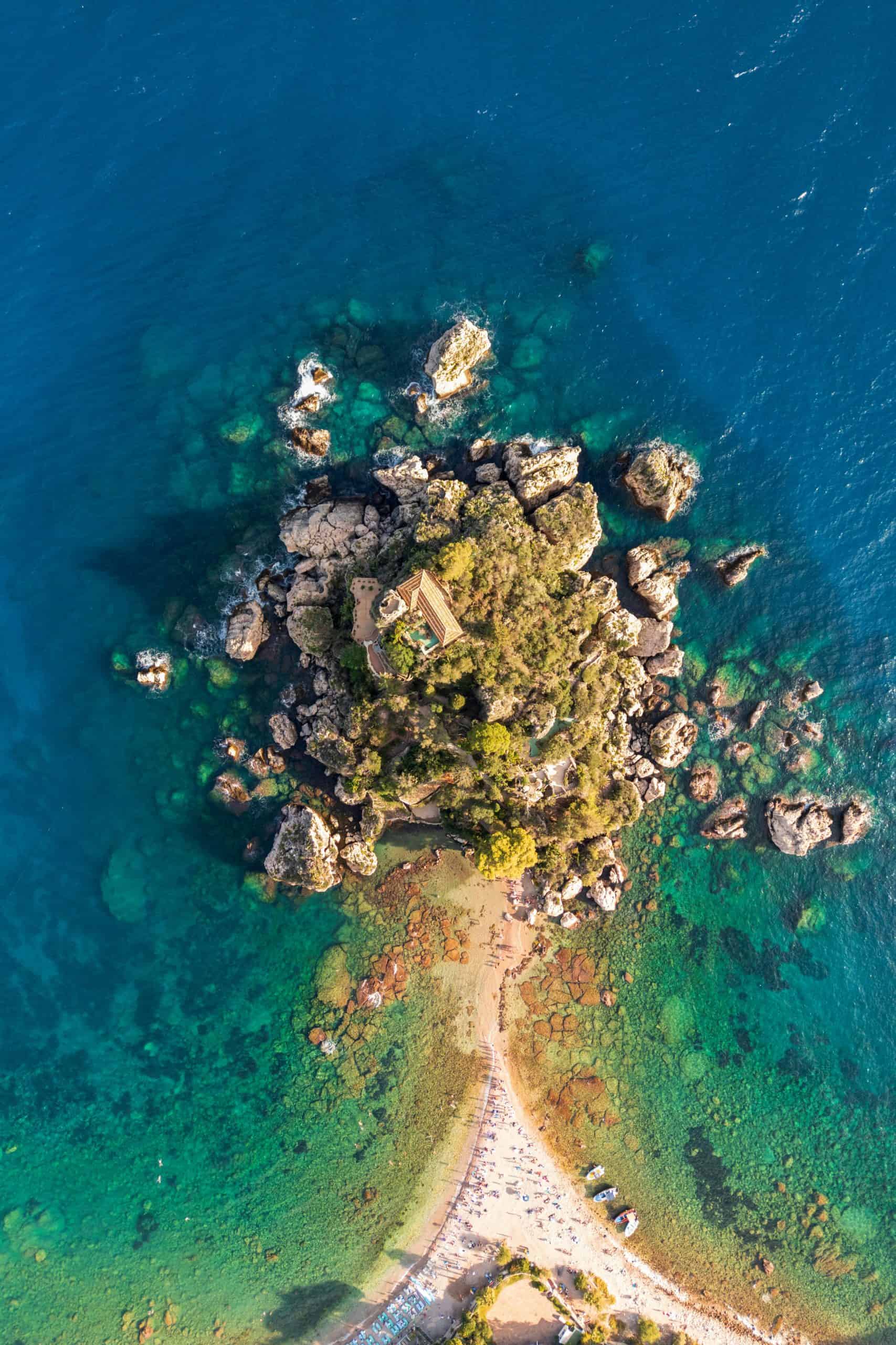 Aerial photo of an island with a pathway to two beaches