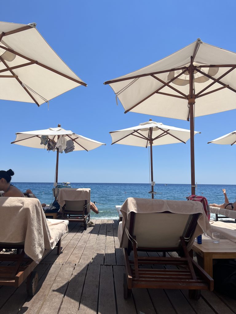 A bunch of beach chairs and umbrellas looking at the sea