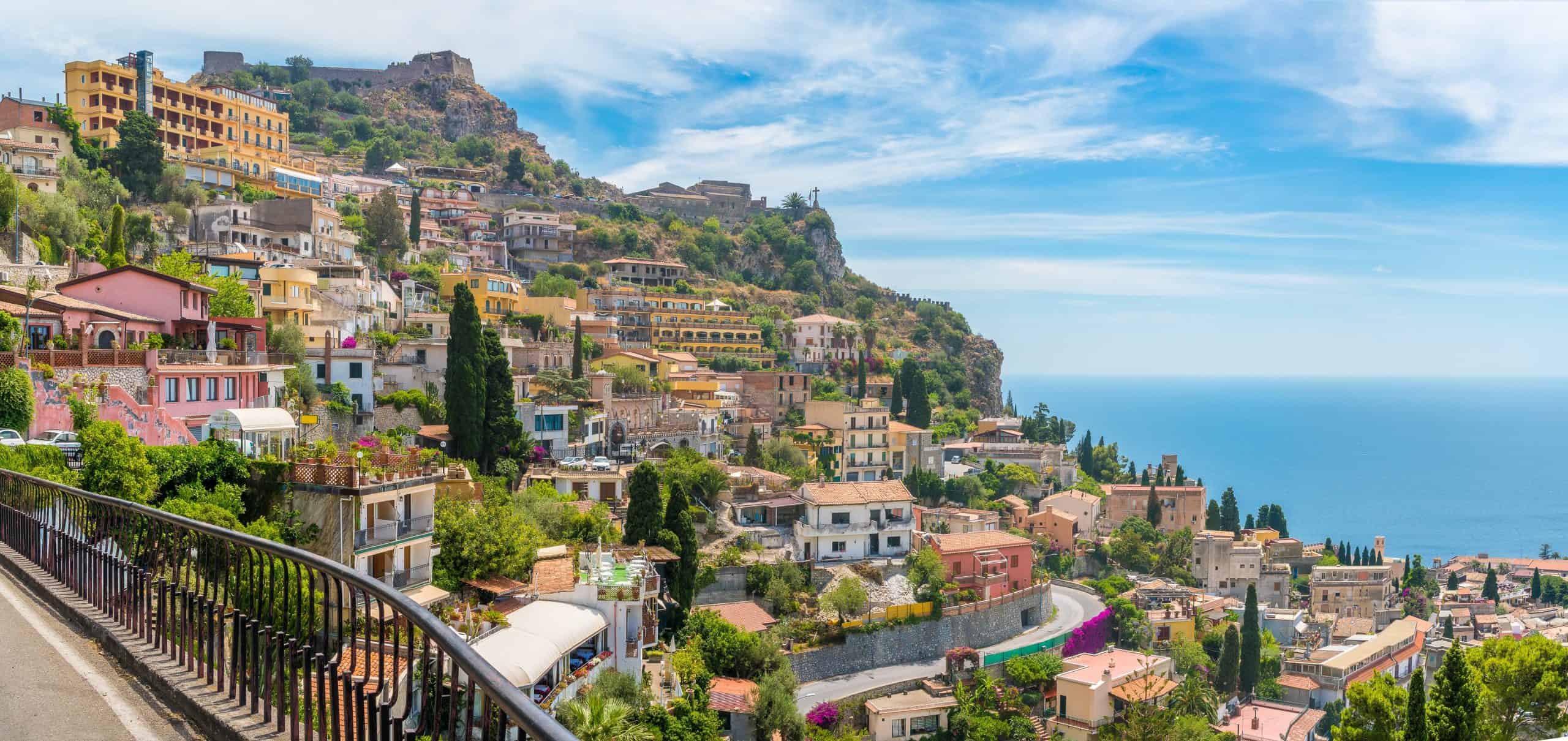 Buildings and homes on a hillside overlooking the sea