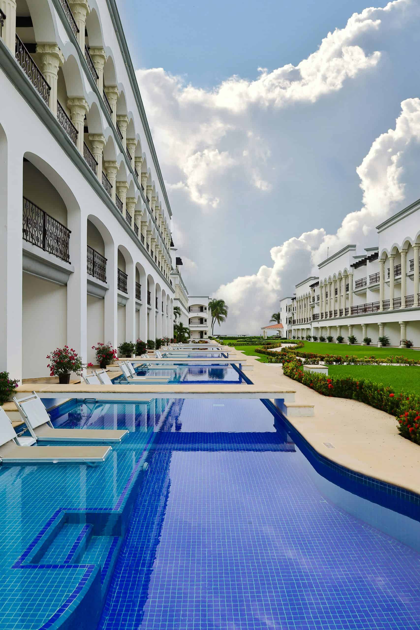 a row of swimup rooms with chairs on water