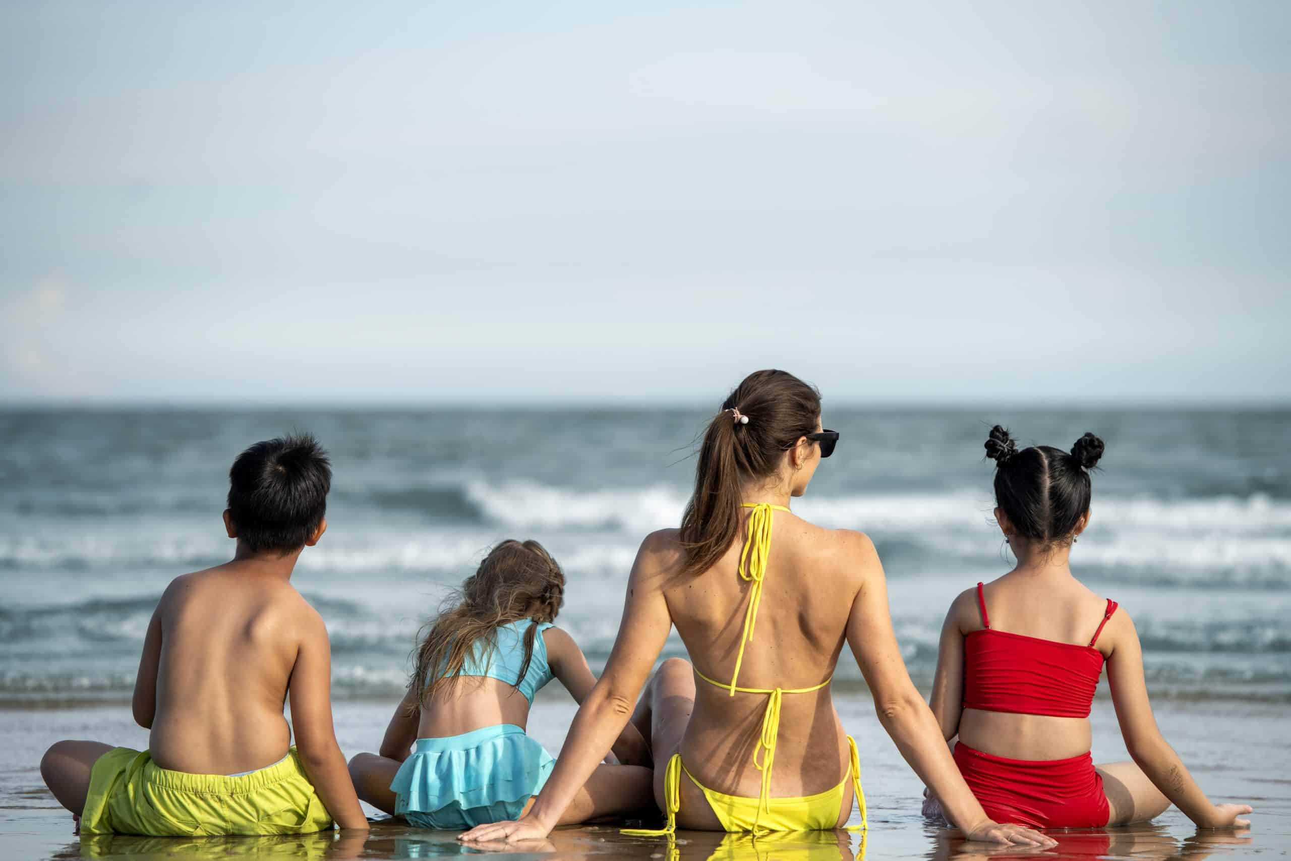 back view woman kids beach