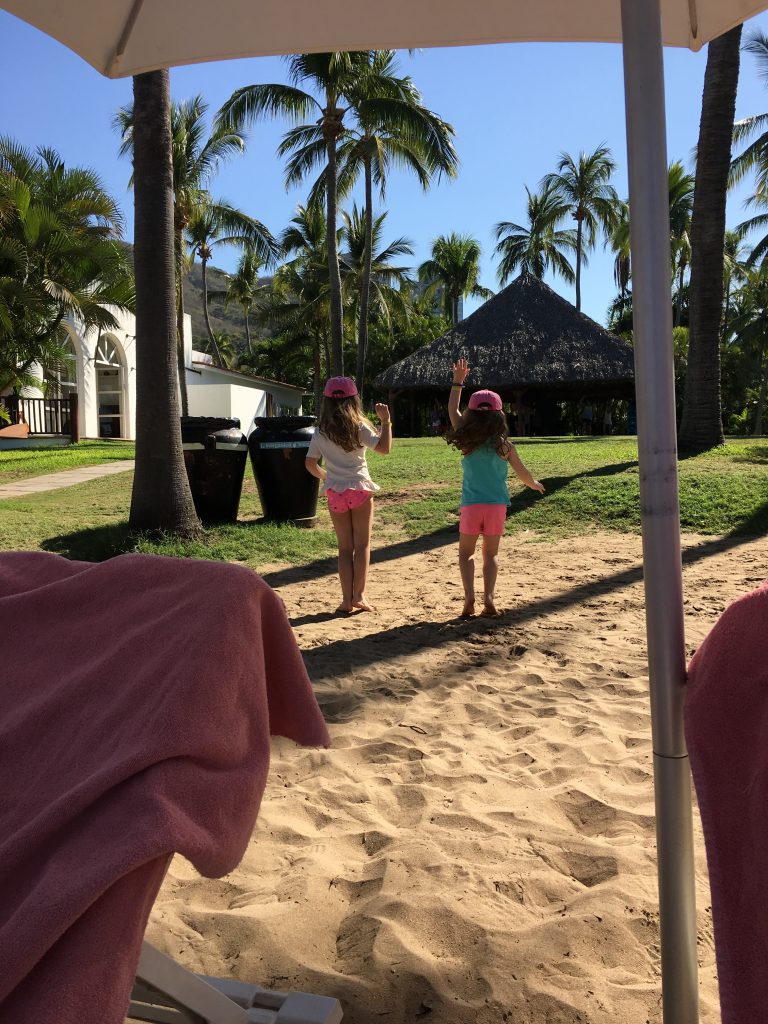 backs of kids dancing under the palapa