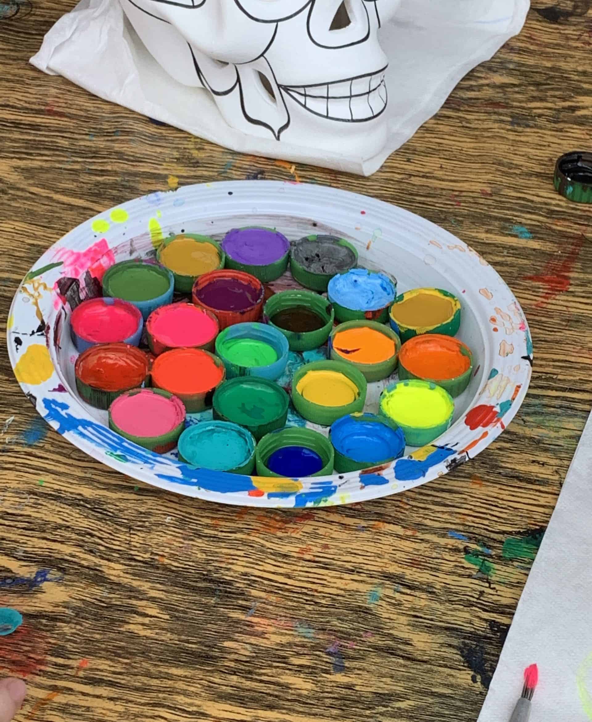 different colour paint with a ceramic mexican face