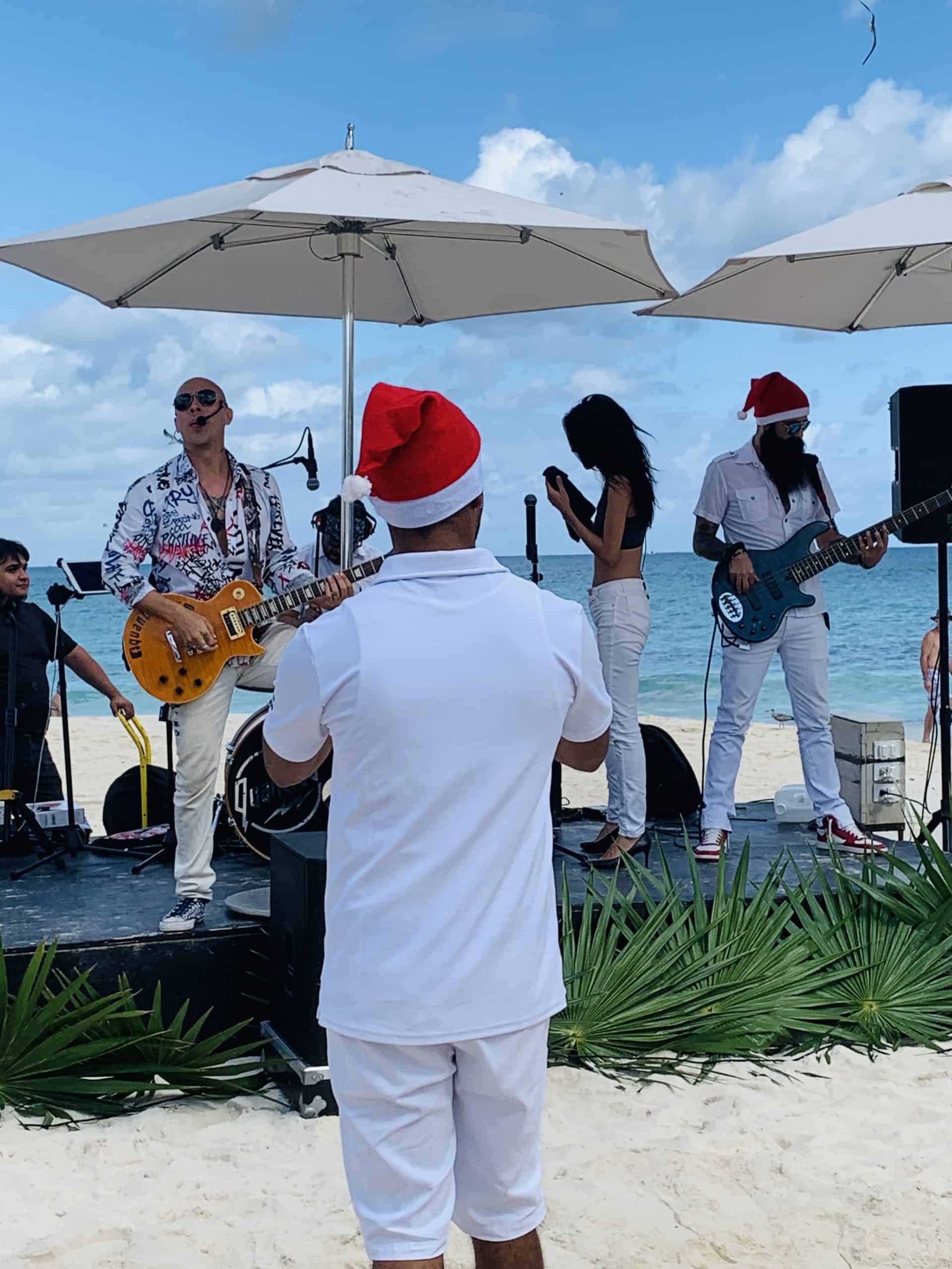 live music band playing on the beach under umbrellas