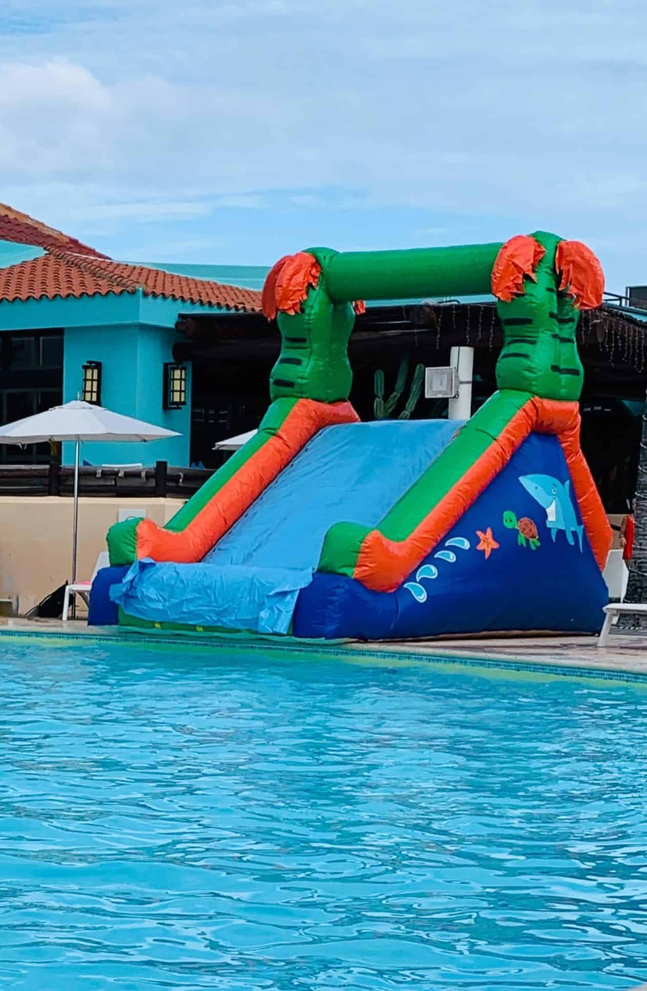 Inflatable water slide in front of swimming pool