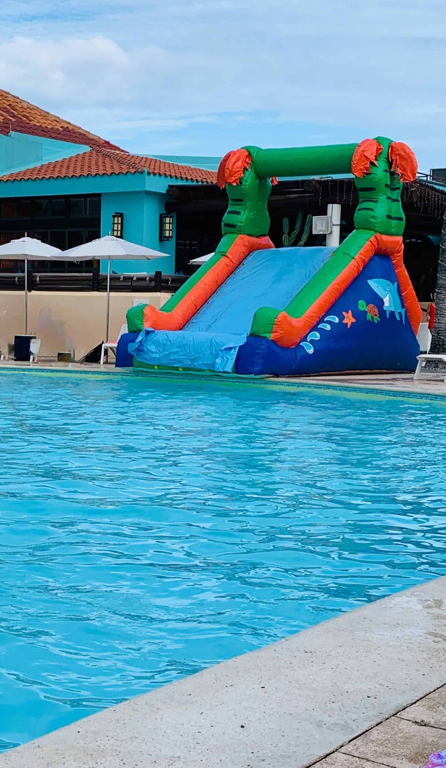 Inflatable water slide in front of swimming pool