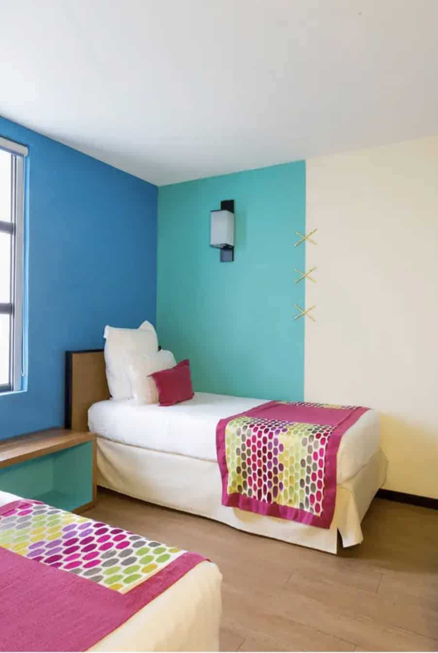 two twin beds in a room with blue walls