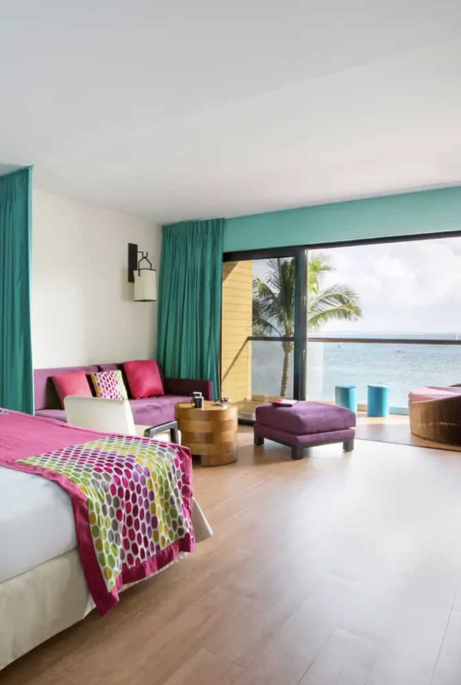Hotel room with couch and bed overlooking the ocean