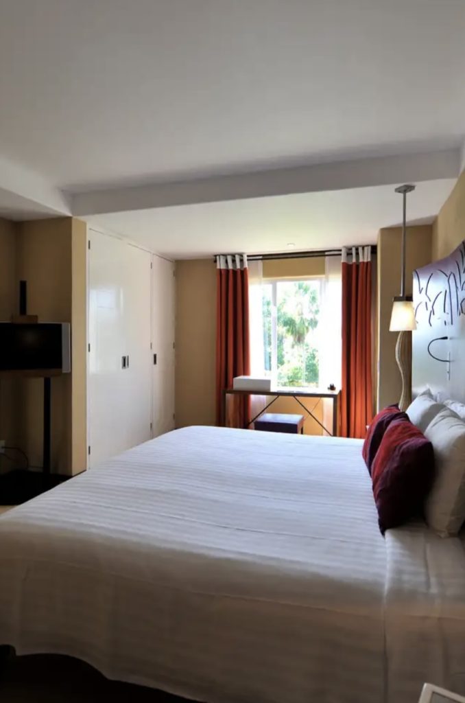 a hotel room with a king size bed