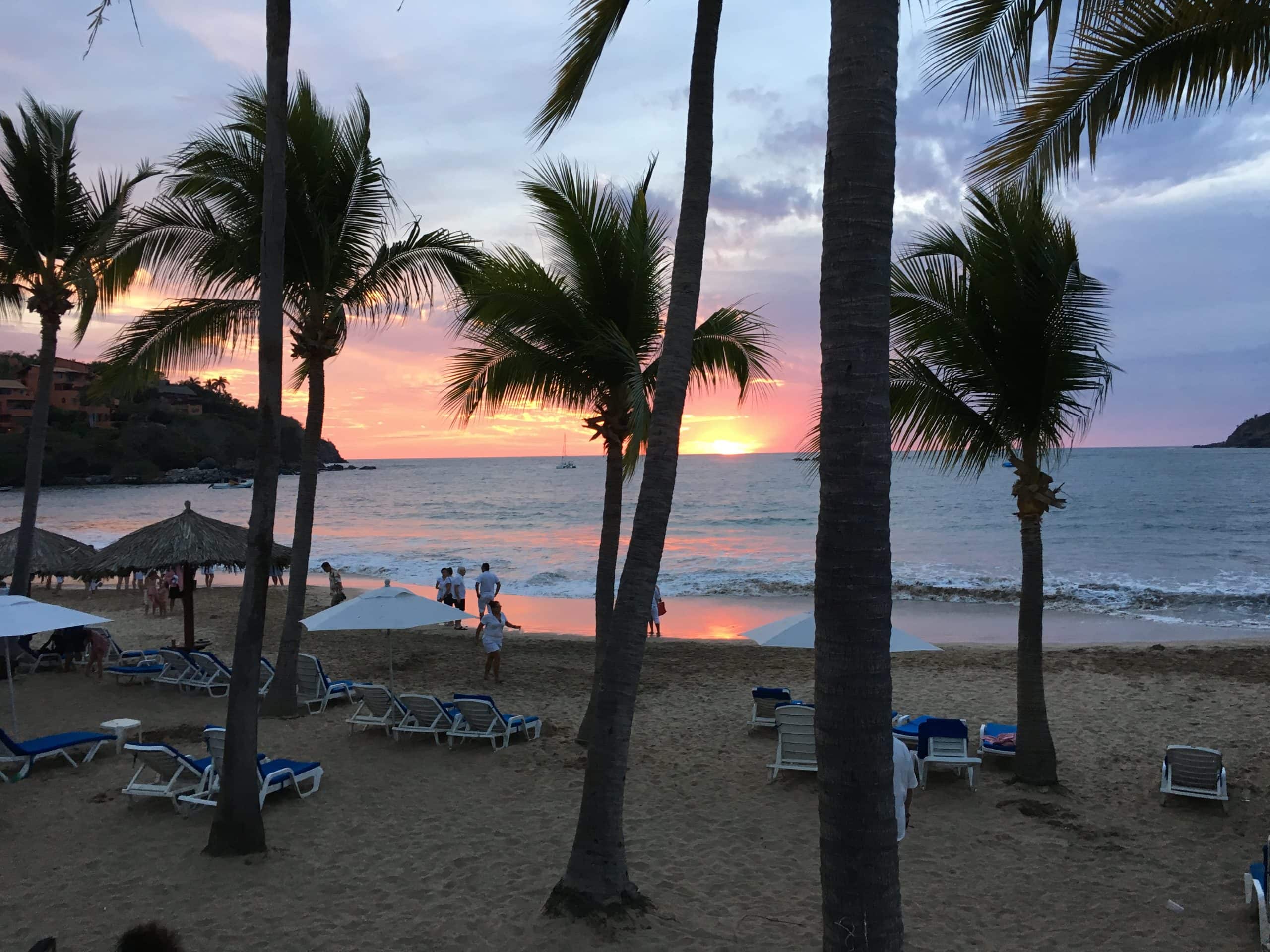 Palm trees on the beach as sunsets at Club Med Ixtapa