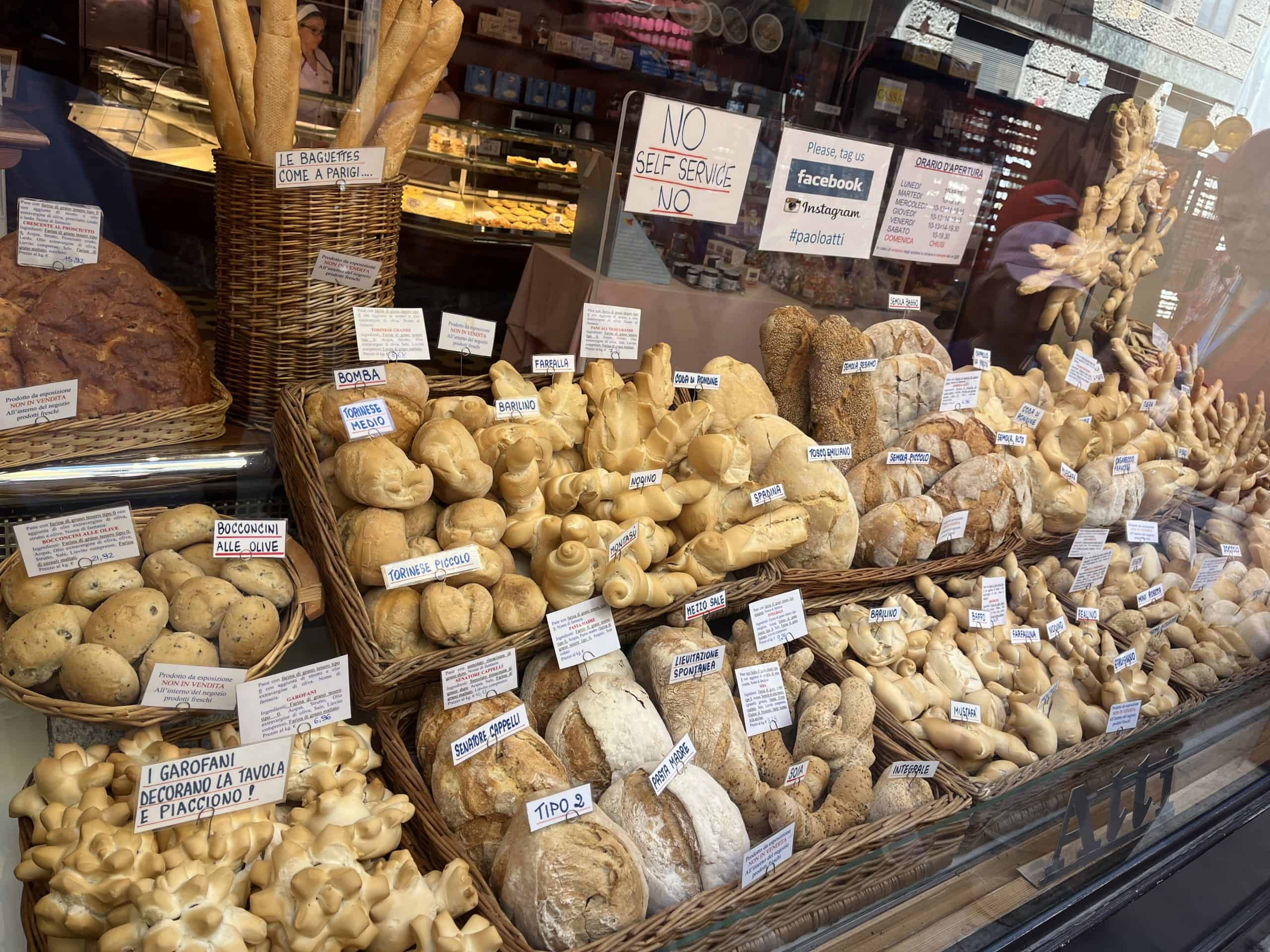 Delicious Italian bread and baked goods display in a bakery shop window.