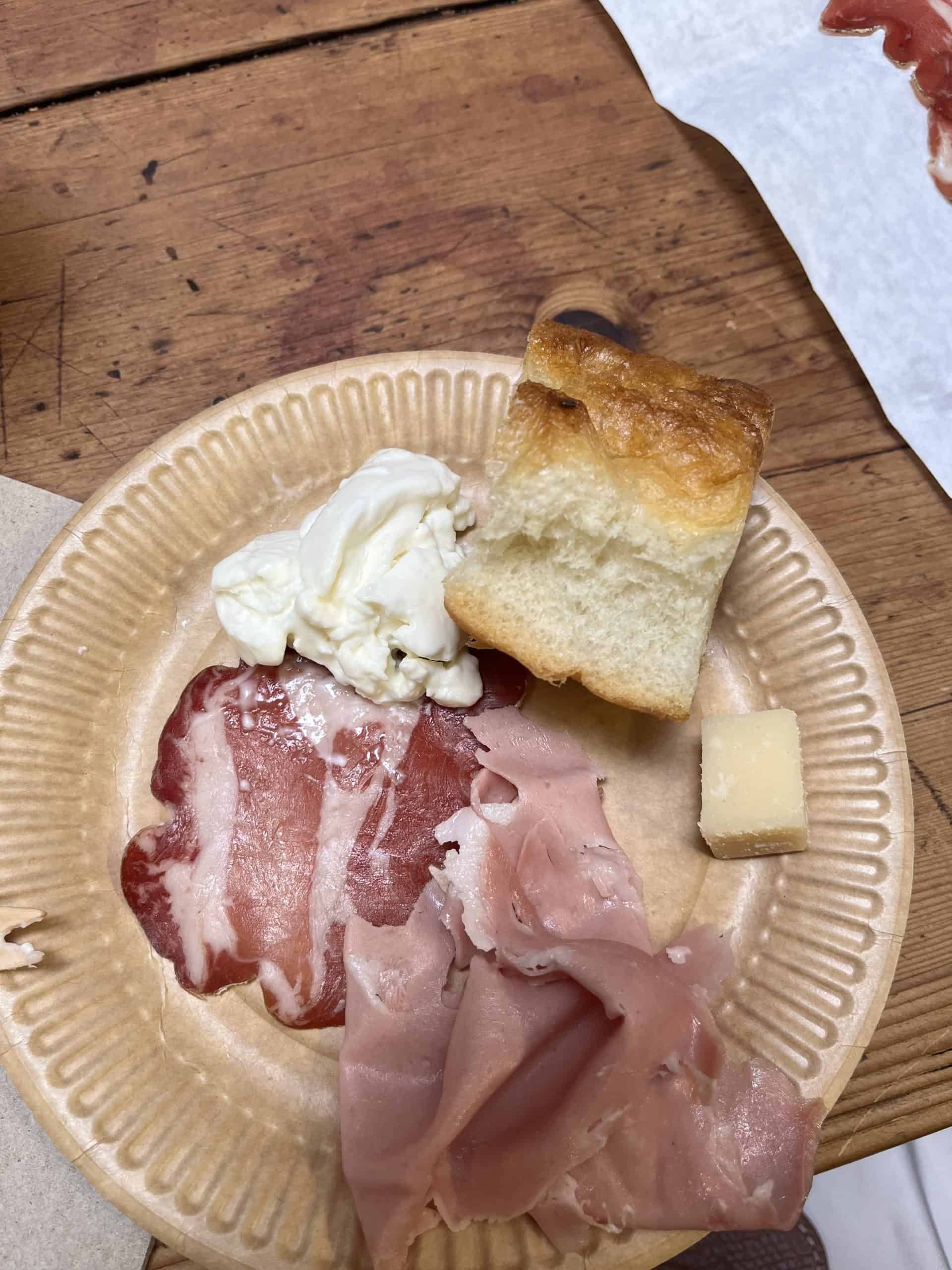 plate with cheese, bread and meat samples