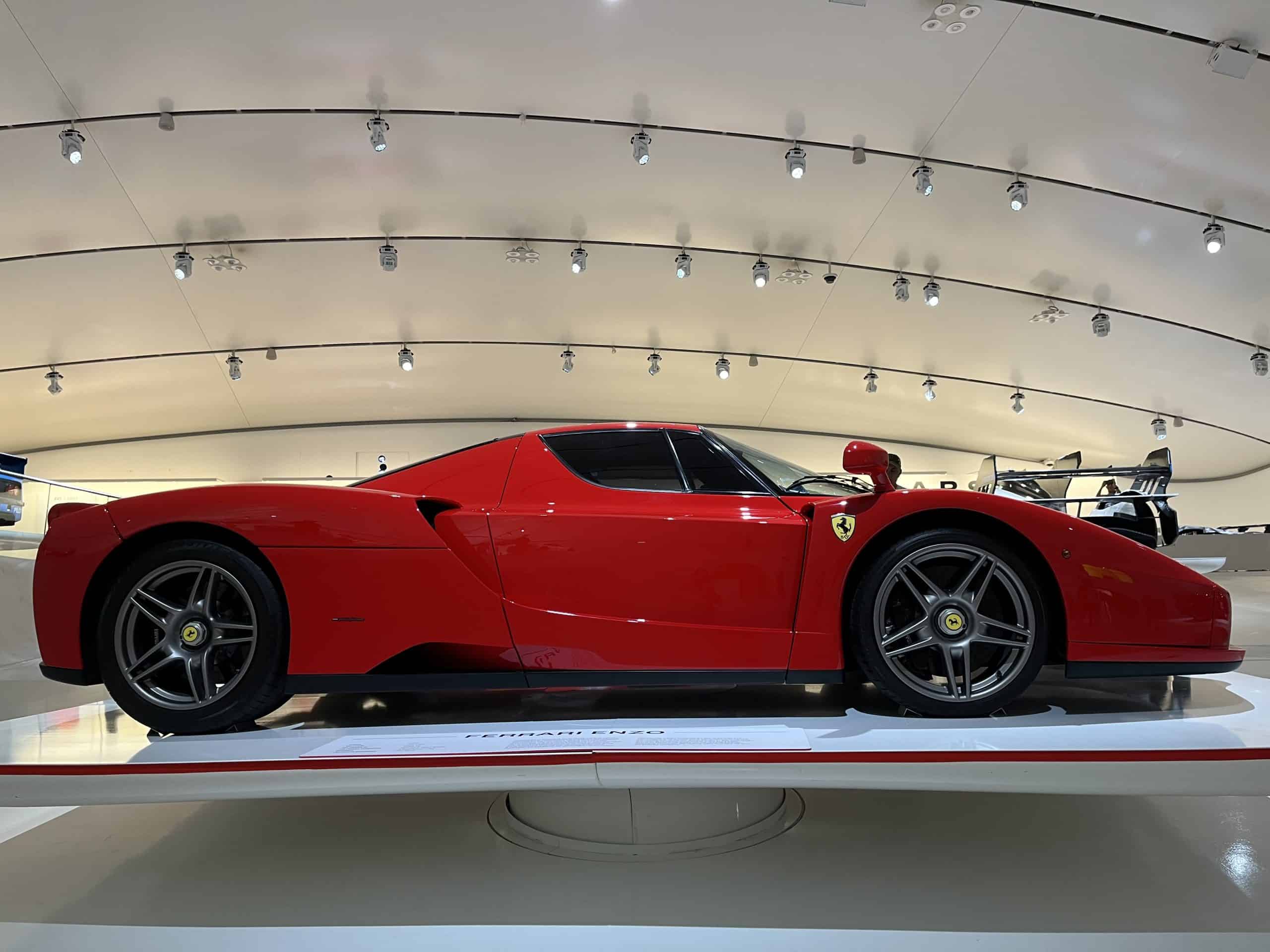 red Ferrari car on platform in the Modena museum