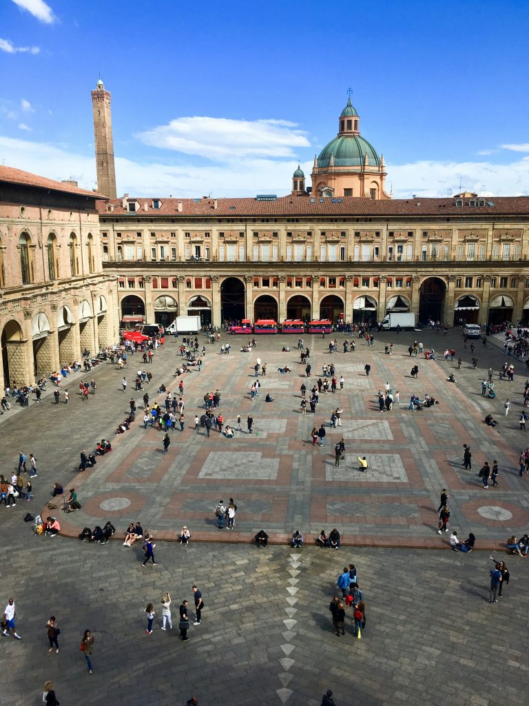 People standing in a square surrounded by buildings in Italy
