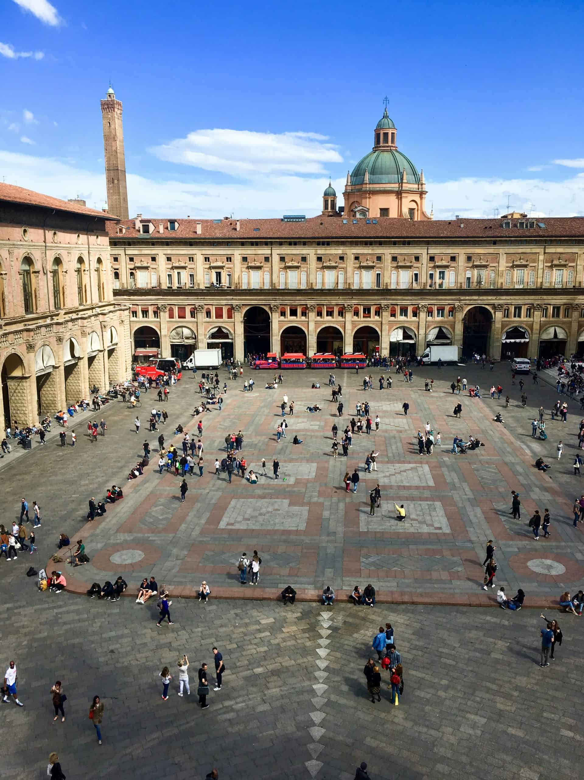 People standing in a square surrounded by buildings in Italy