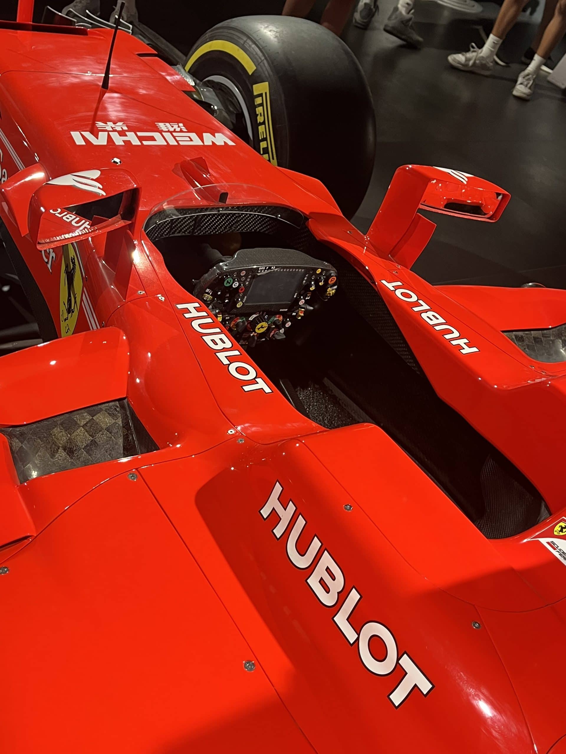 Ferrari Formula 1 race car with Hublot branding at a motorsport exhibit.