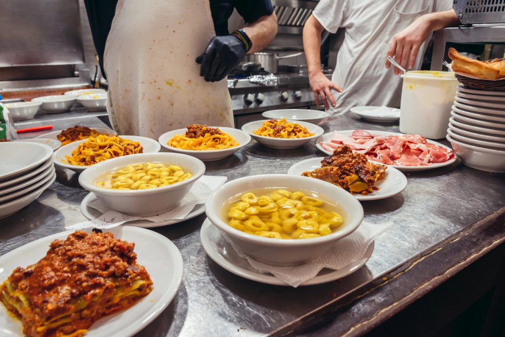 Plates of lasagna, tortellini and ragu bolognese