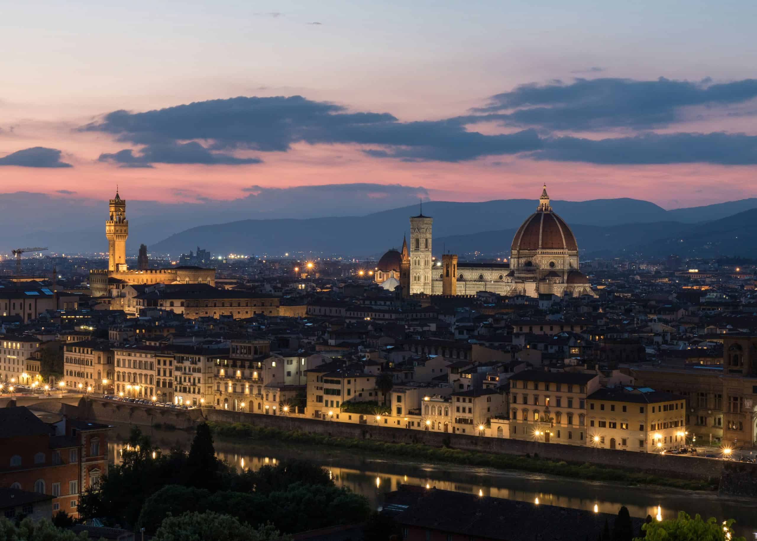 Panoramic view of Florence's historic cityscape, including the Duomo at dusk.