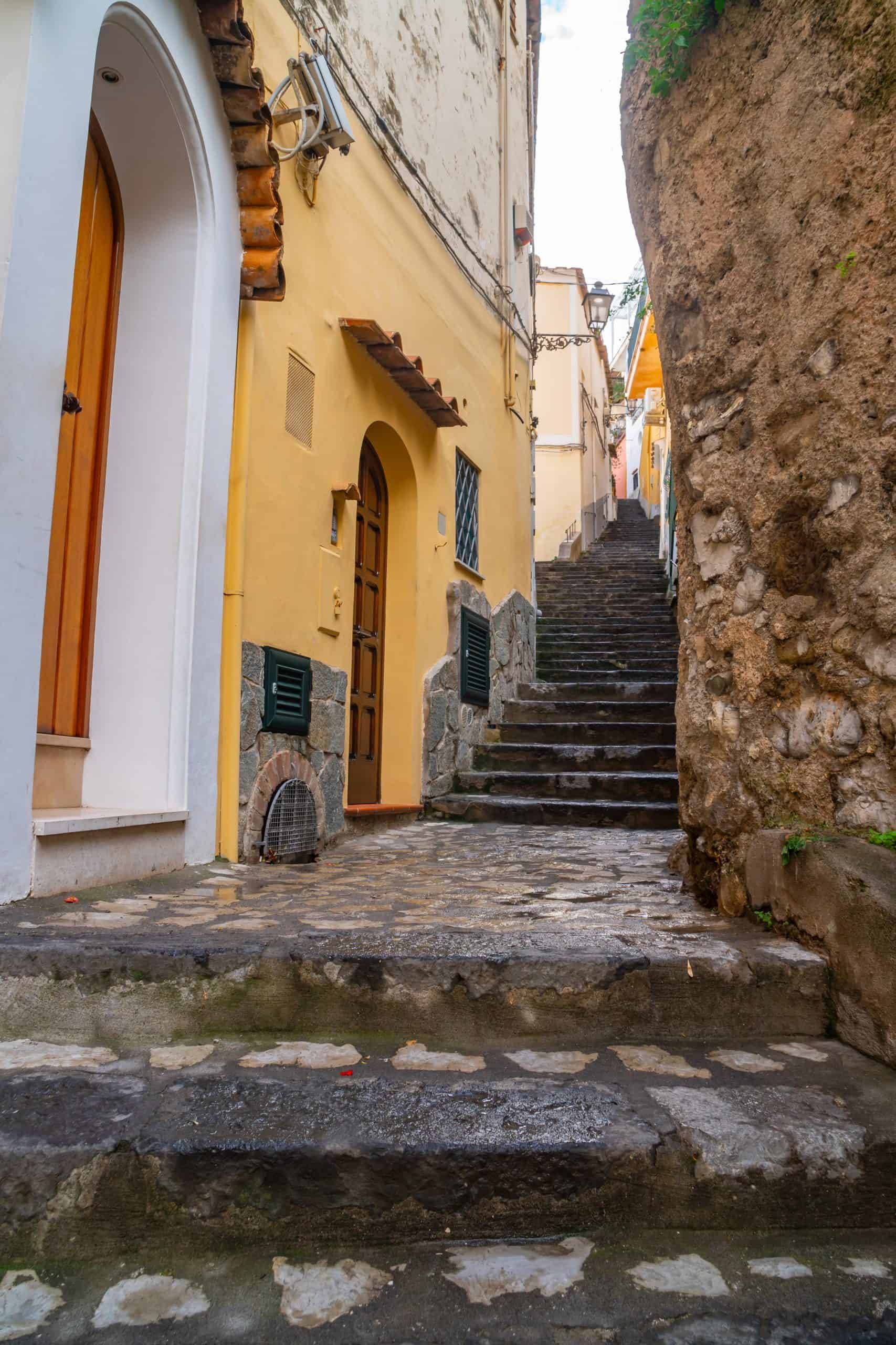 Flights of stairs in a narrow alleyway with buildings on either side