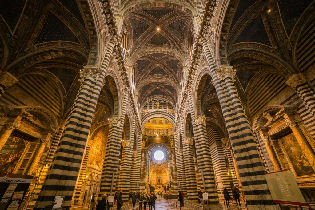 Breathtaking Siena Cathedral interior showcasing intricate Gothic architecture and stunning striped marble columns.