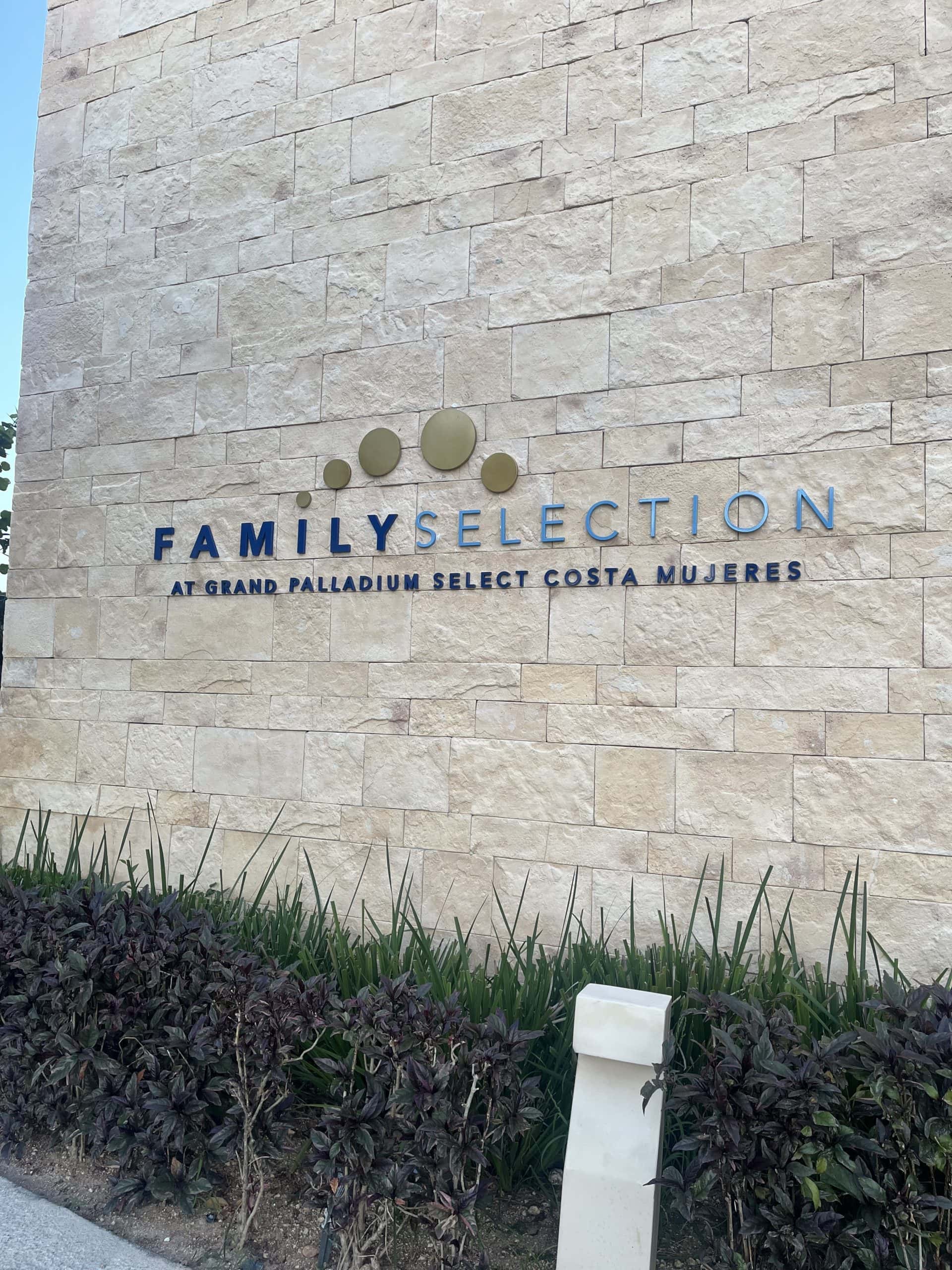 Building with a sign that says Family Selection Grand Palladium Select Costa Mujeres