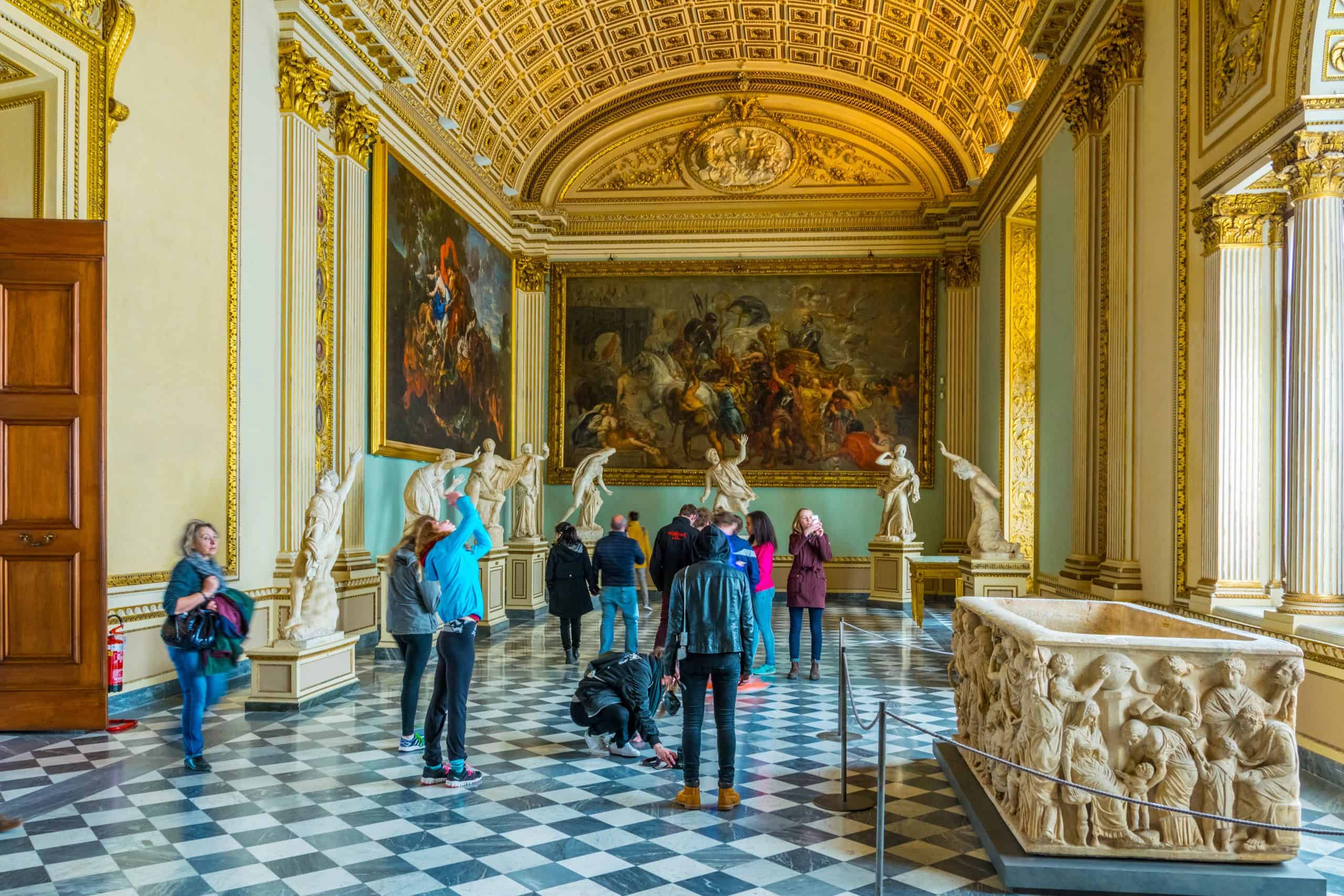 Visitors looking at paintings in the Uffizi Gallery