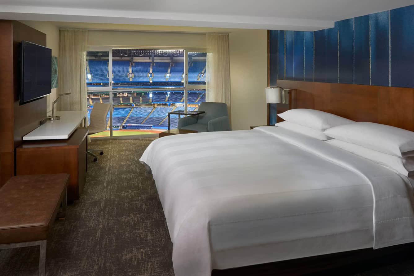 Hotel bed overlooking baseball stadium