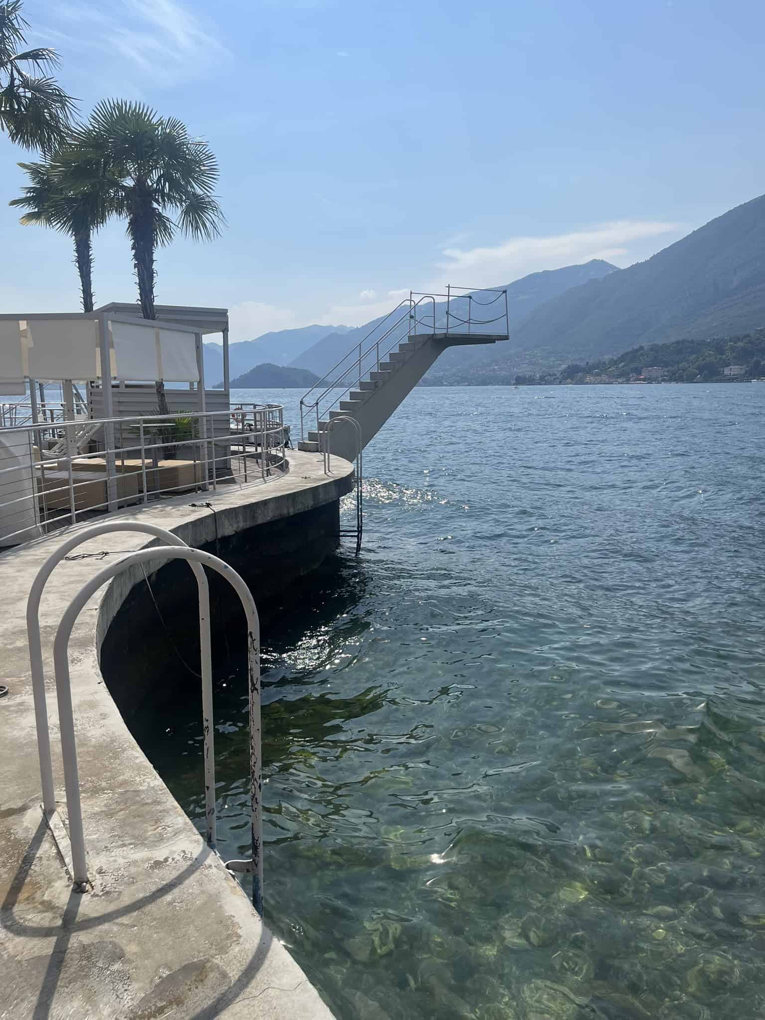 ladder to lake water with mountain behind it