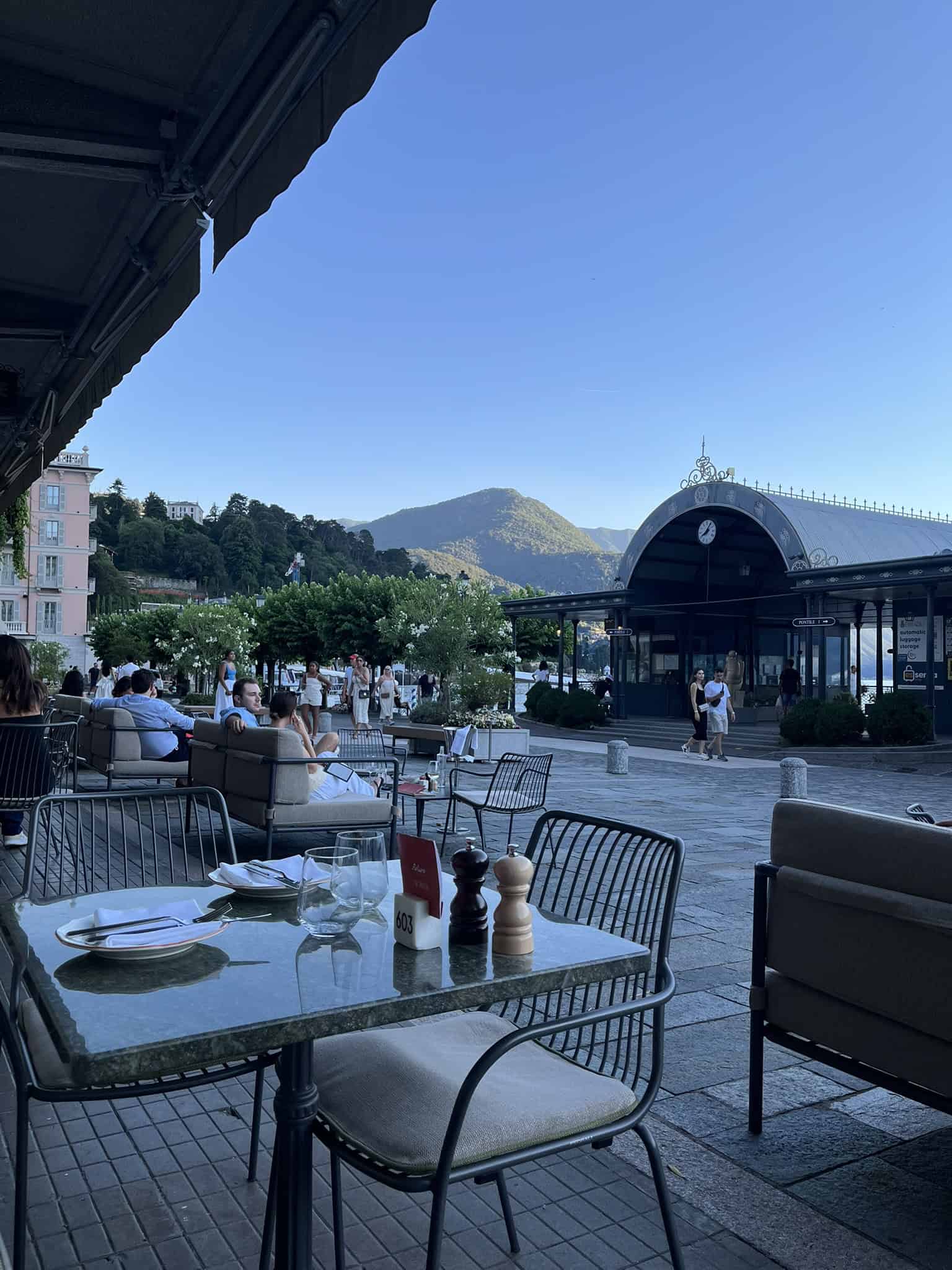 People sitting on couches while having dinner across from the mountains