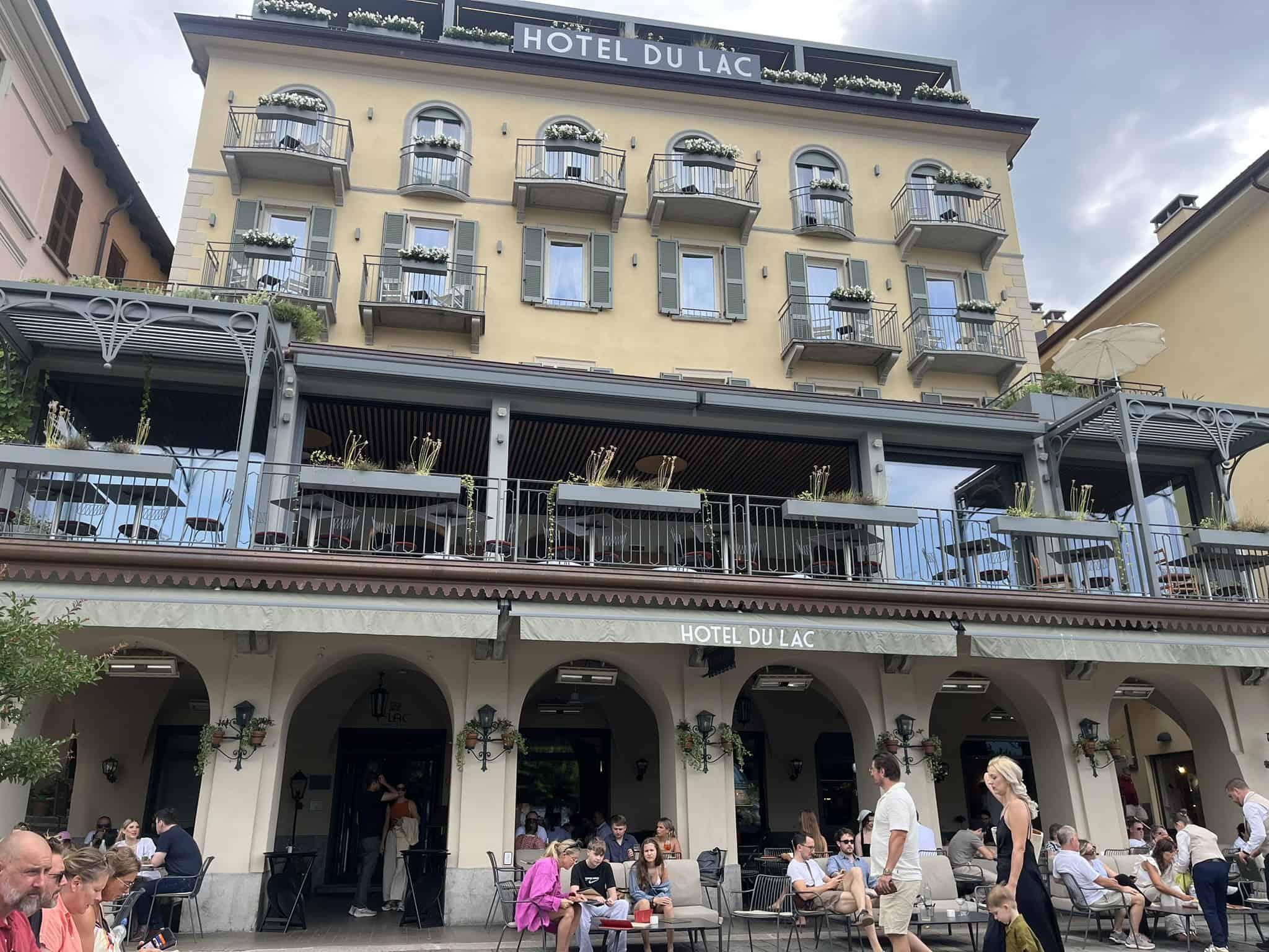 yellow facade of hotel with windows and a balcony