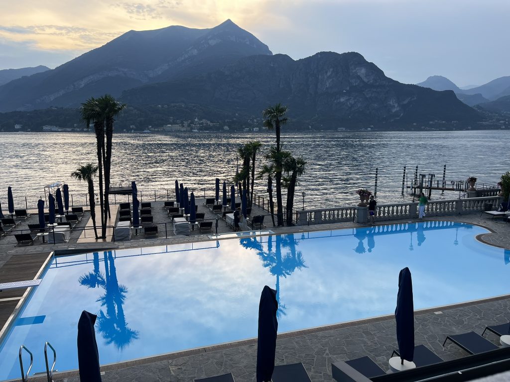 Outdoor swimming pool overlooking Lake Como with mountains in the background